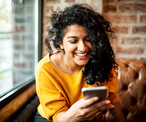 woman smiling at phone