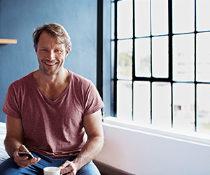 man on phone smiling at camera