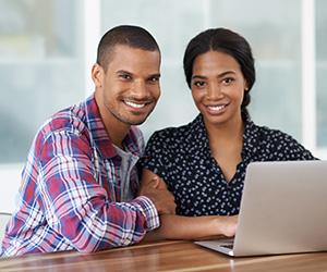 woman and man looking at computer