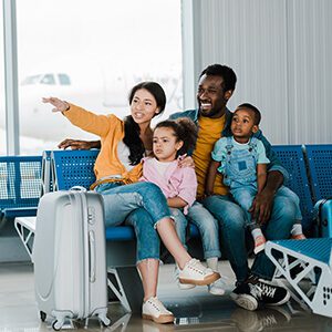 family at airport with mom pointing 